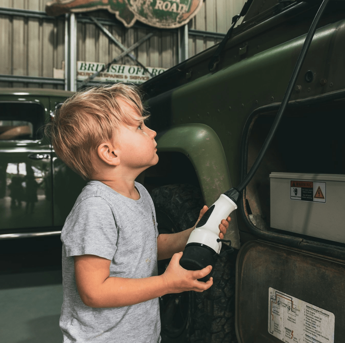 Child looking at converted electric vehicle